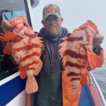 Capt. Andy Martin of Brookings Fishing Charters holds a pair of tiger rockfish his customers caught May 5 near the Point St. George Reef lighthouse aboard the Nauti-Lady.