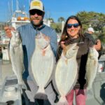 Alex Niapas and Clara Ricabal with Hook’d Up bay halibut and striped bass